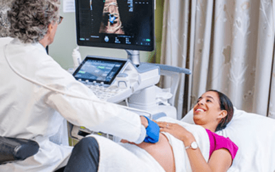 Doctor taking ultrasound of pregnant woman